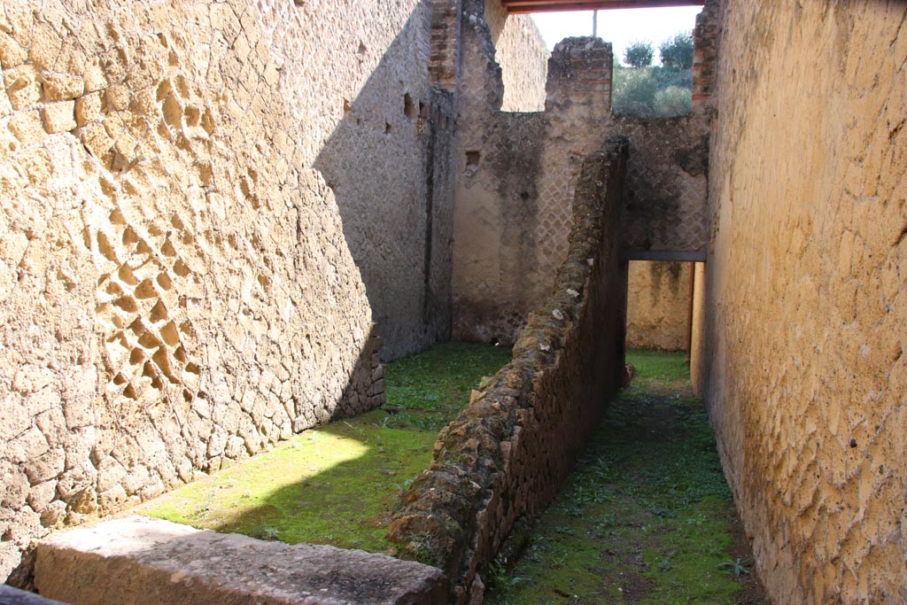 Ins. Or. II.7, Herculaneum. October 2022. Looking east from entrance doorway.
Two doorways into rooms on the first floor can be seen in the upper centre of the photo. Photo courtesy of Klaus Heese.